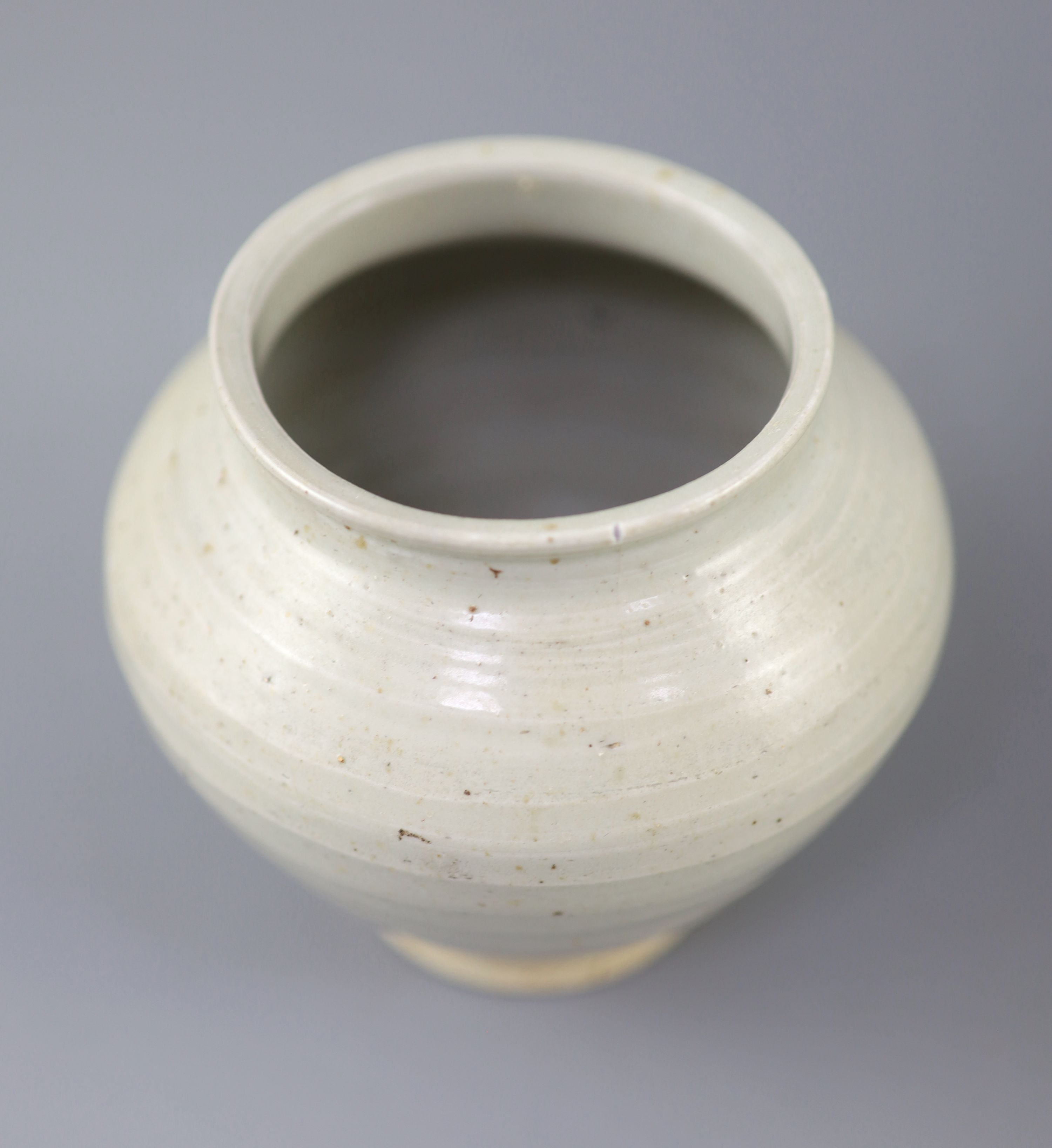 A Chinese cream glazed ovoid jar, Tang dynasty and a Ding type jar and cover, Yuan dynasty,